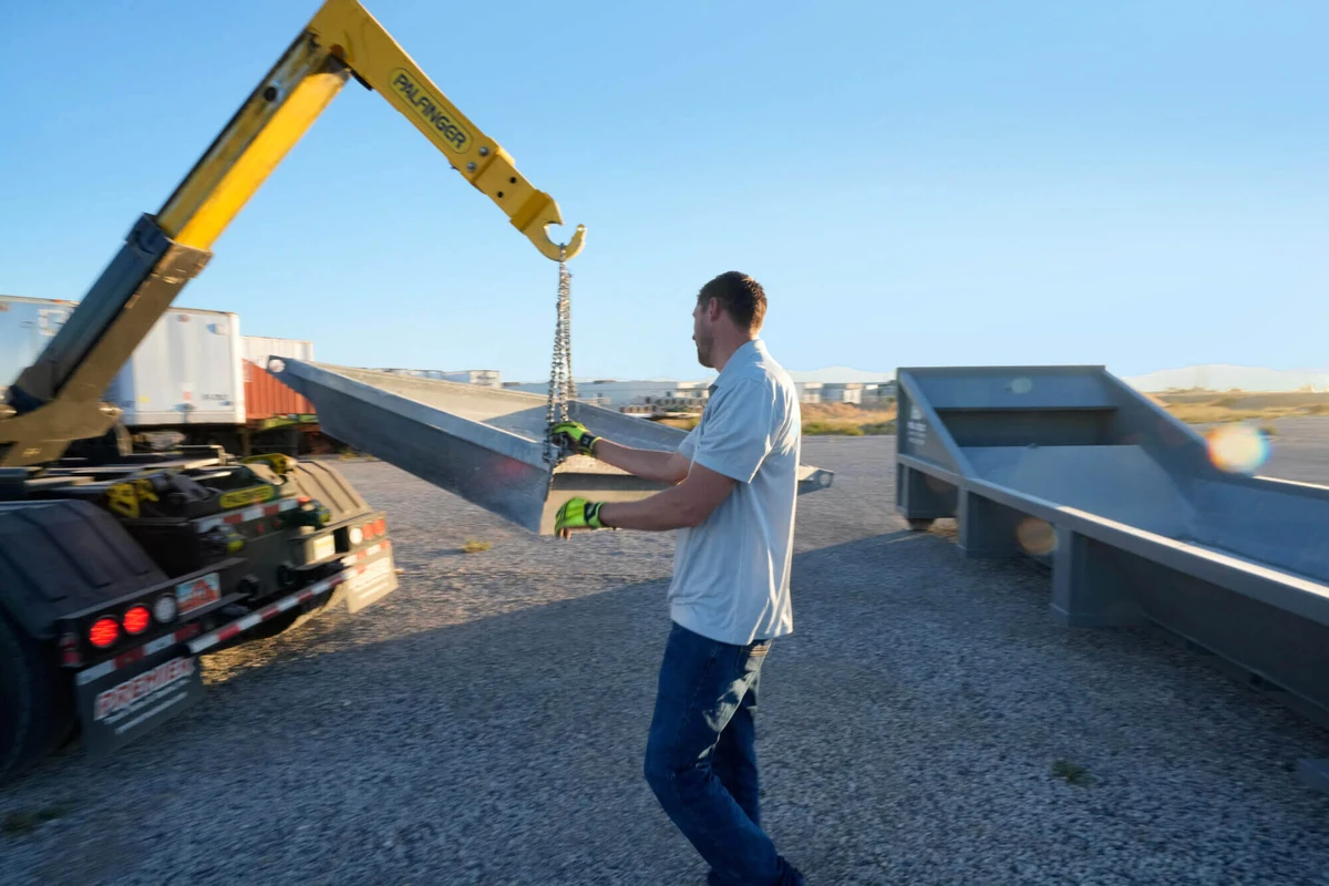 Concrete washout equipment being handled at a jobsite